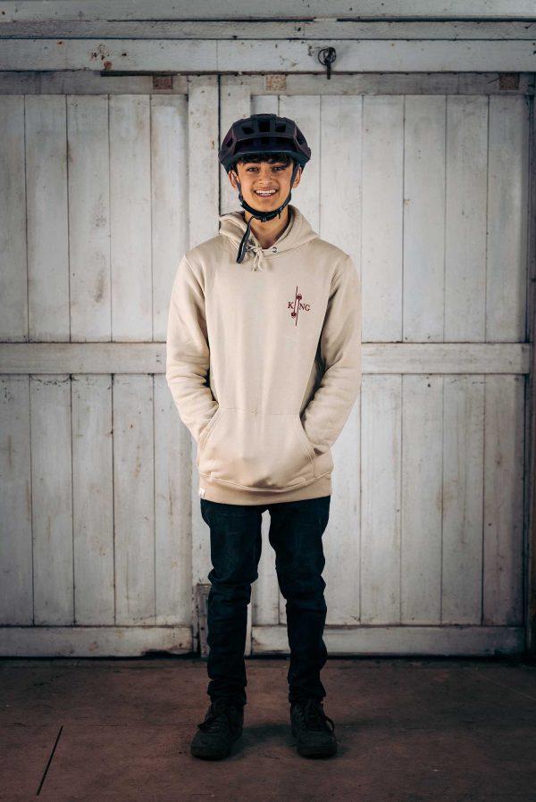 Boy wearing King of Spades hoodie in oatmeal colour.